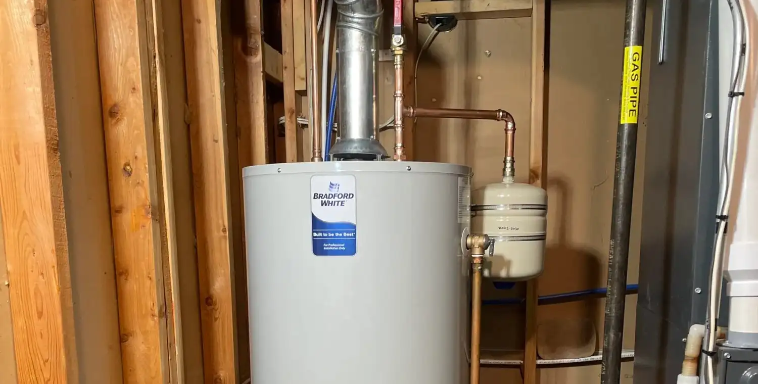 A gas water heater with its flue, copper supply lines and thermal expansion tank